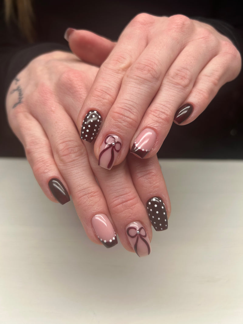 Close-up of hands with decorative nail art on a neutral background open red gel cabaret 150