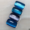 Four blue gel polish color swatches showing turquoise shimmer, teal holographic, black silver glitter, and navy metallic finishes