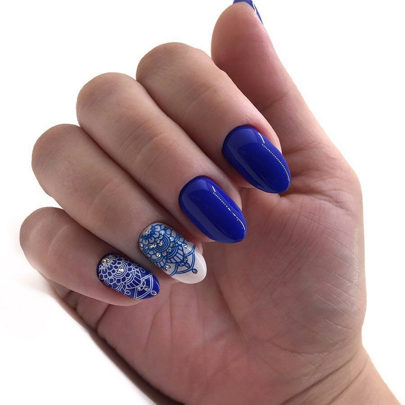 manicure with neon blue nail polish created from stamping plates